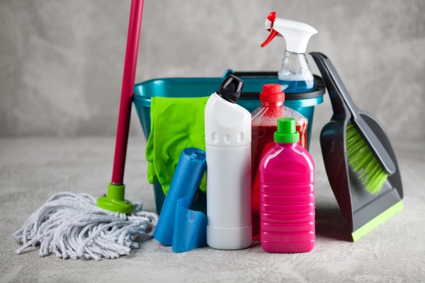 Cleaning supplies including mop, bucket, and spray bottles.